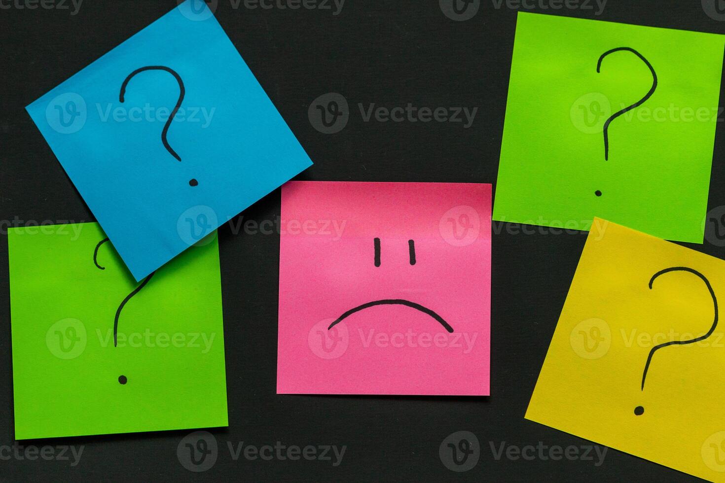 upset emoticon surrounded by question marks on a dark background, failed attempts, motivation photo