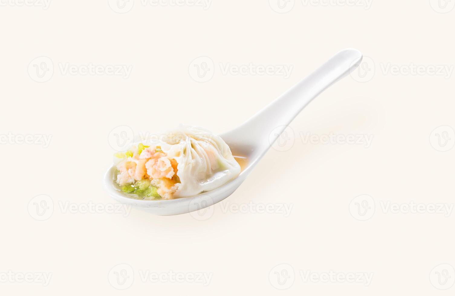Green Squash and Shrimp Xiao long bao steamed bun dumpling served in spoon isolated on grey background side view of hong kong food photo
