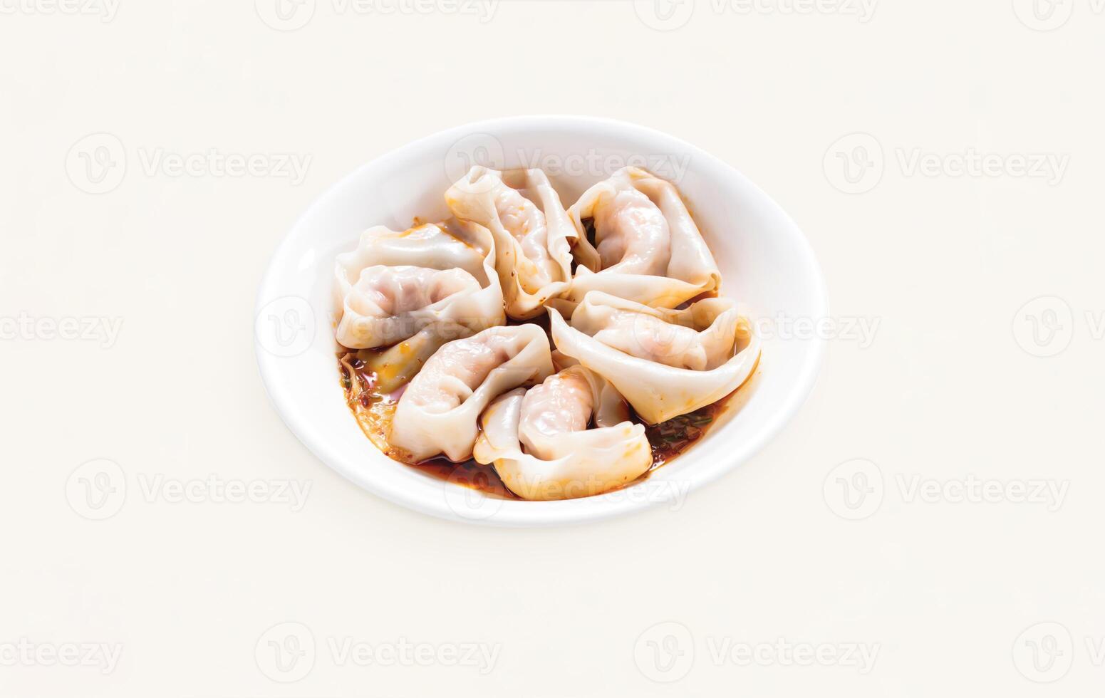 Dumplings, Wontons, Shao Mai, Shrimp and Pork Wontons with spicy Sauce served in plate isolated on grey background side view of hong kong food photo