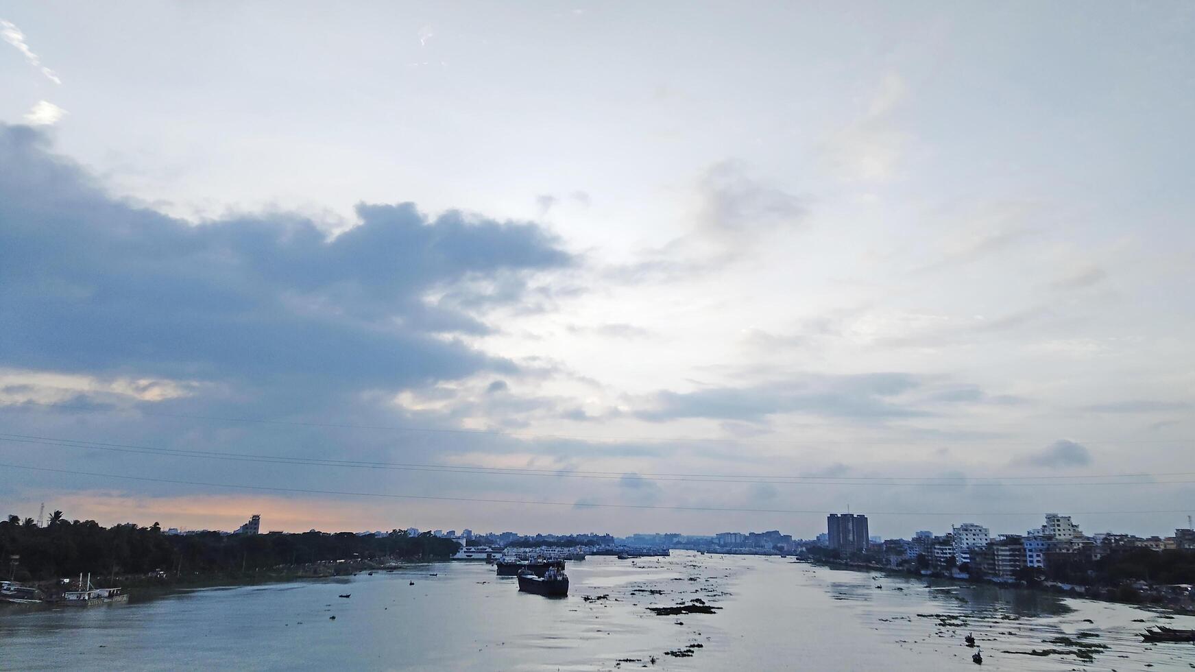 Beautiful scenery of colorful clouds reflecting in the river during sunset photo