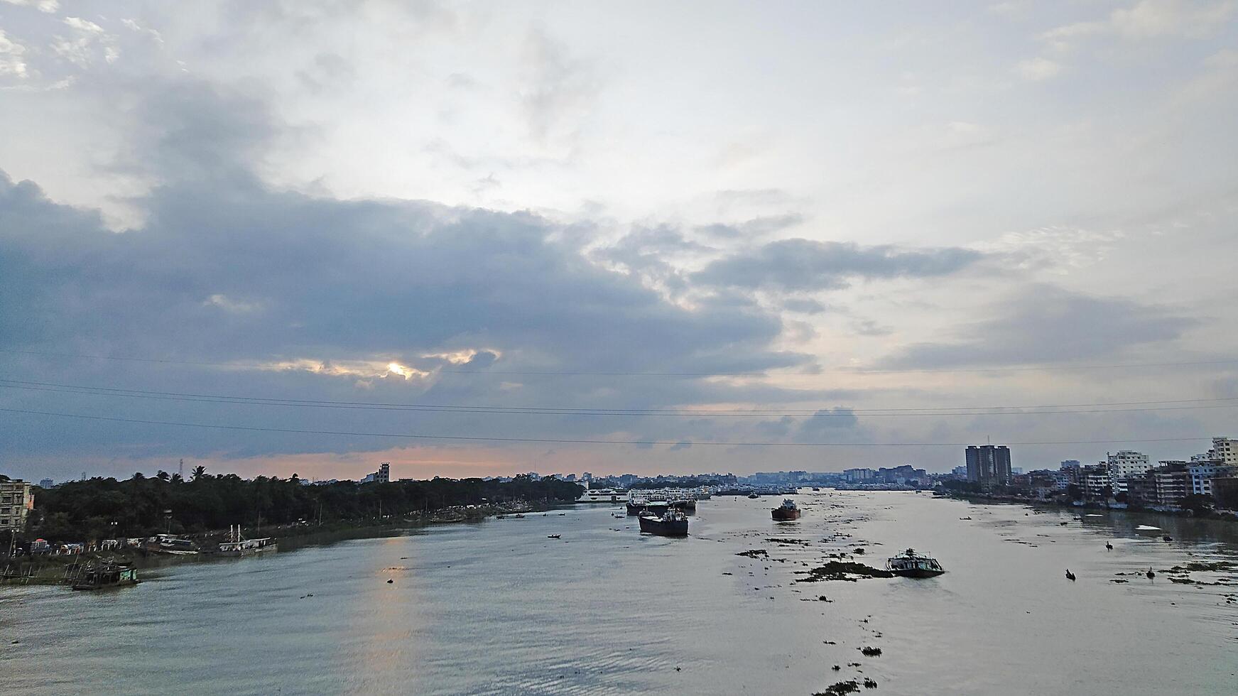 Beautiful scenery of colorful clouds reflecting in the river during sunset photo