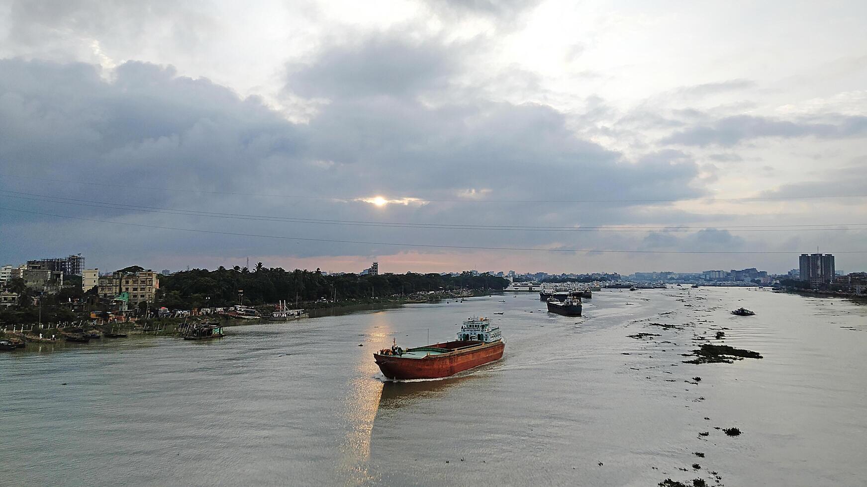 Beautiful scenery of colorful clouds reflecting in the river during sunset photo
