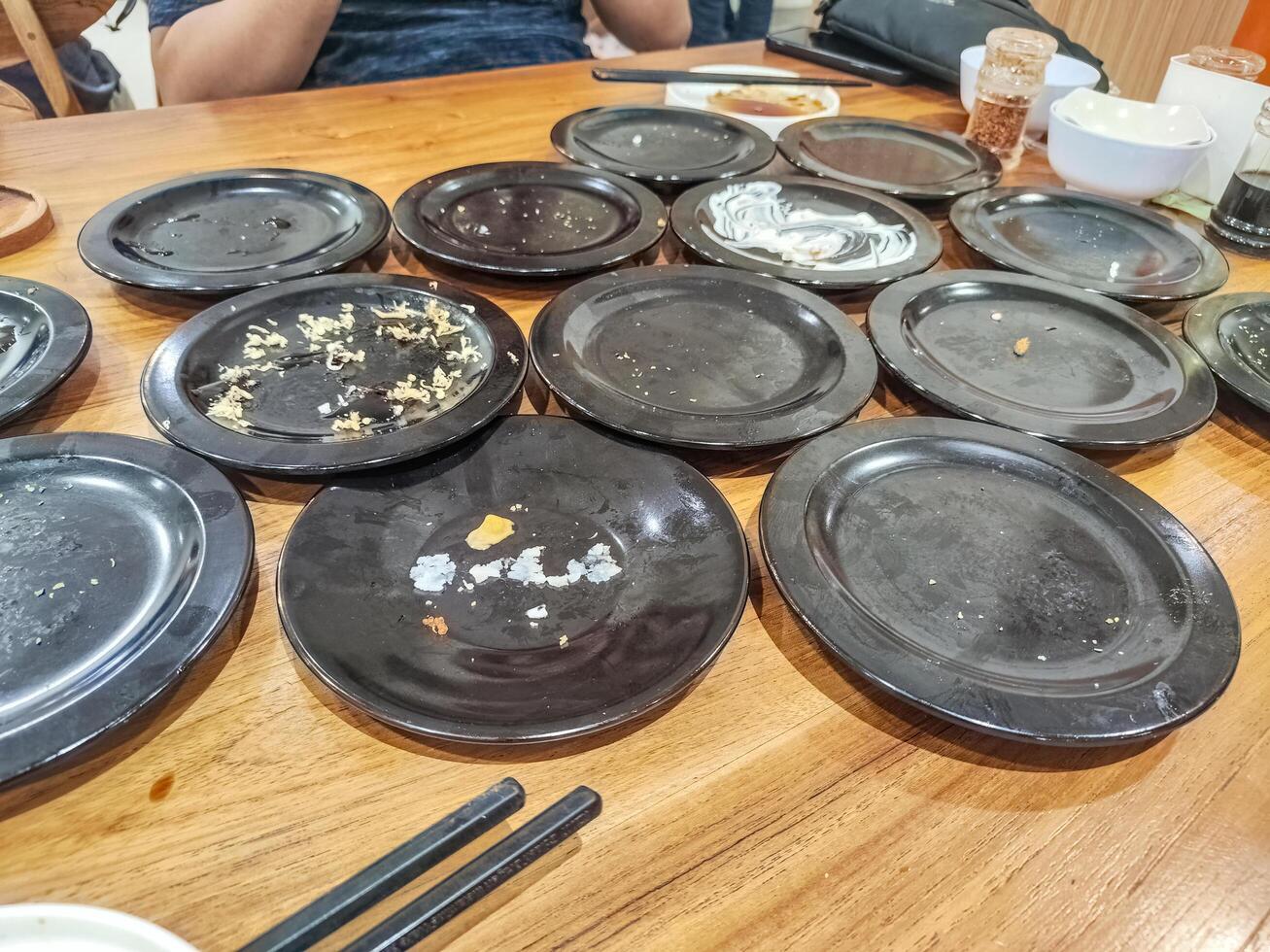 many leftover plates of sushi food in Japanese restaurants. hygiene and health content. photo