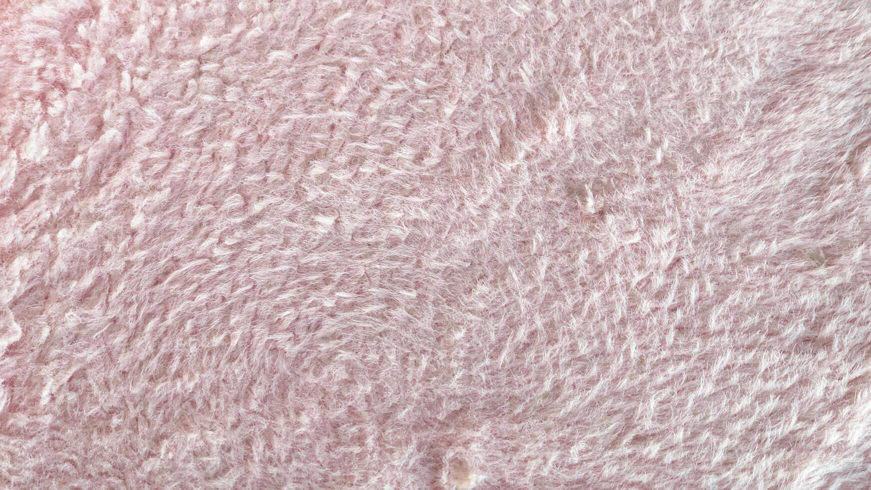 Close-up of soft pink fluffy fabric texture. Ideal for backgrounds, textures, or overlays photo
