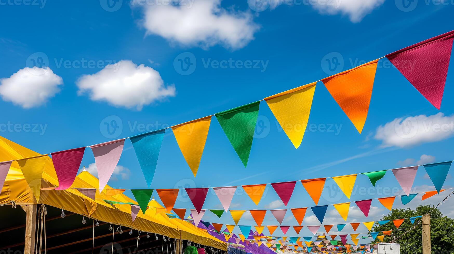 Charming village fair with colorful bunting and quaint stalls under a bright blue summer sky photo