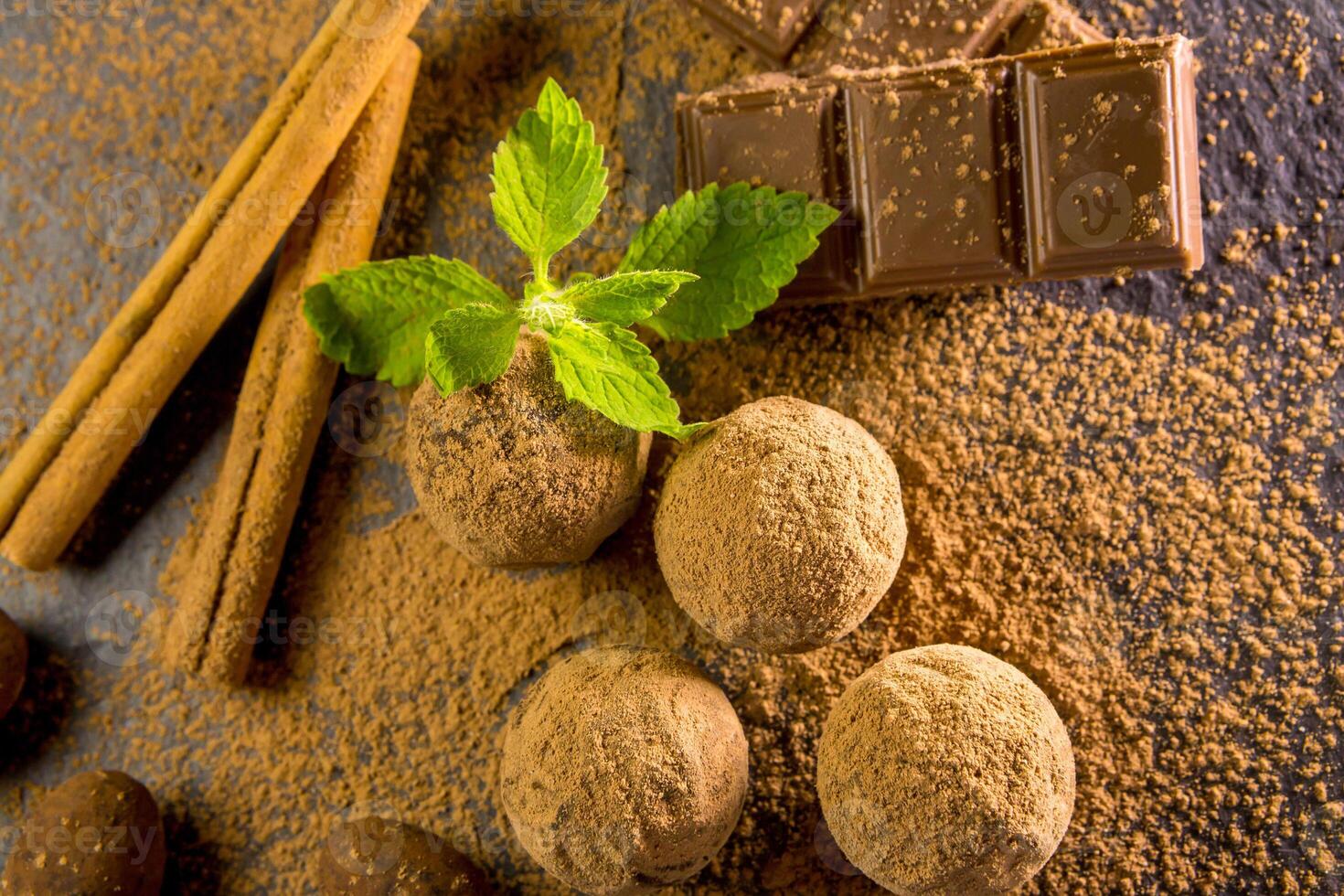 Chocolate truffle. Chocolate sweets on the table with mint and vanilla on the table photo