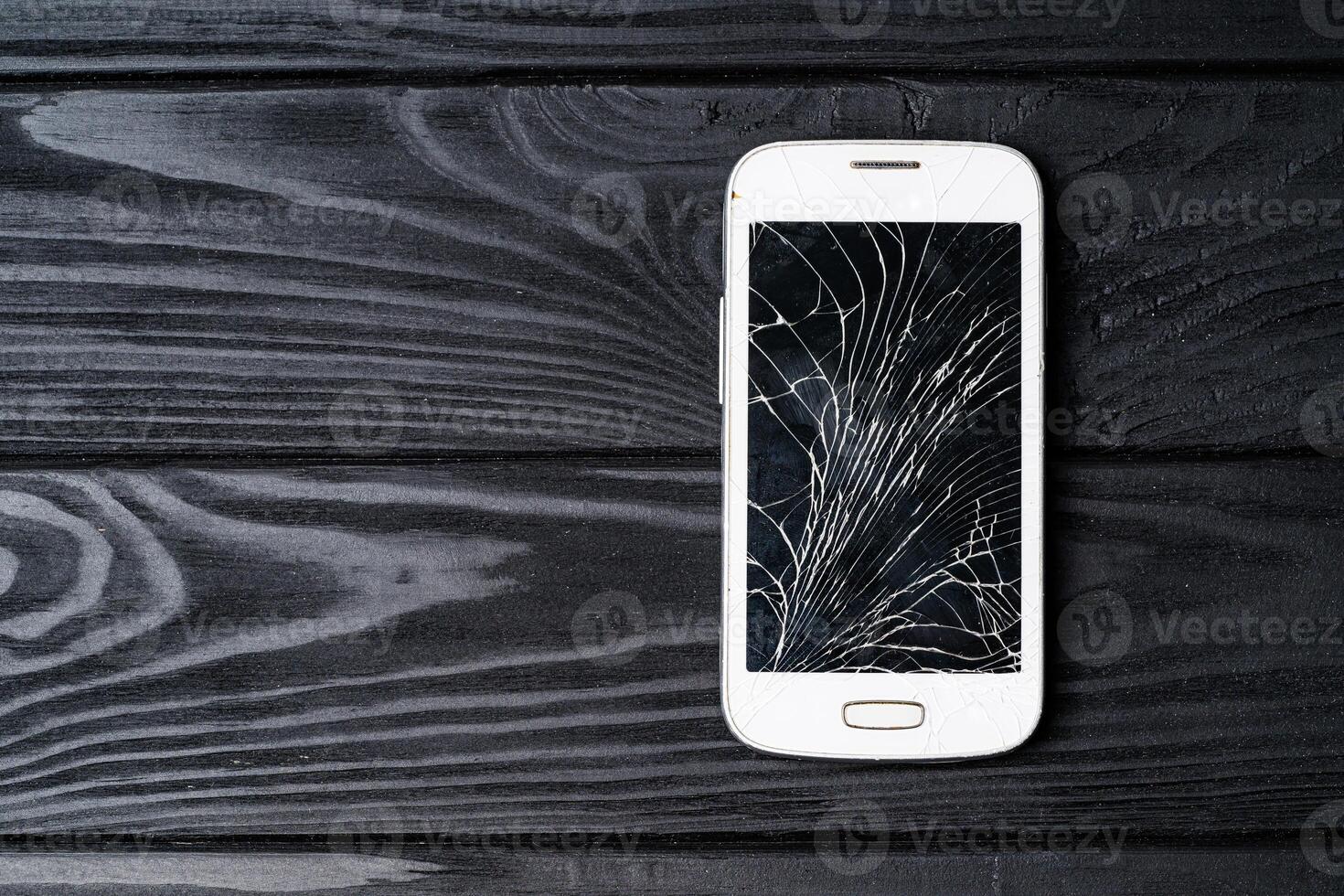 Broken phone screen. Smartphone with broken screen photo