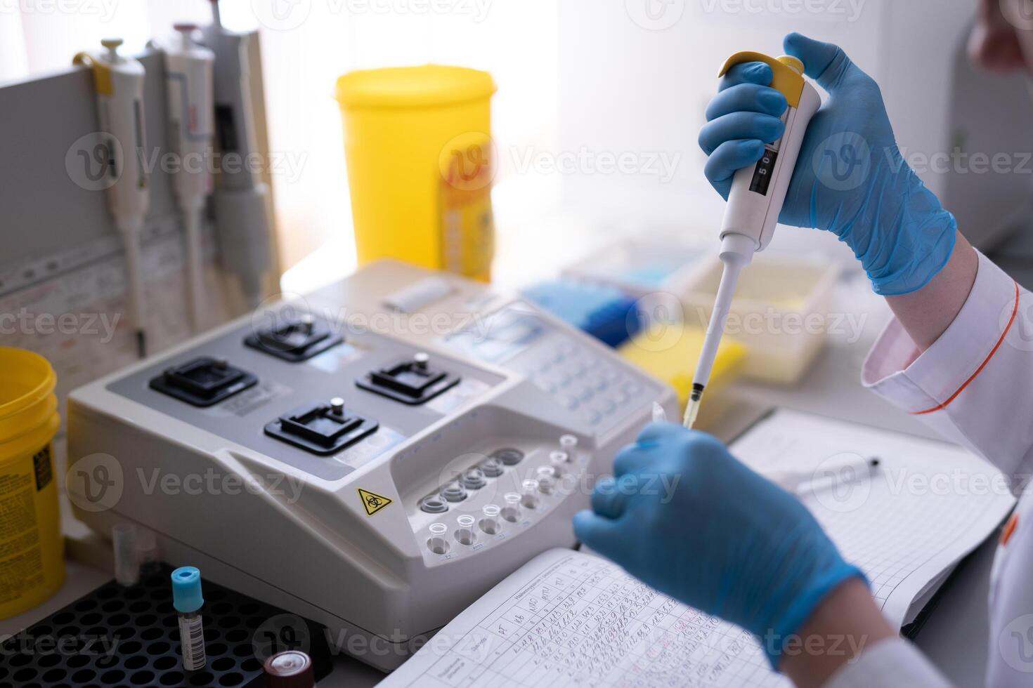 Female Research Scientist Uses Micro Pipette while Working with Test Tubes. Medical equipment photo