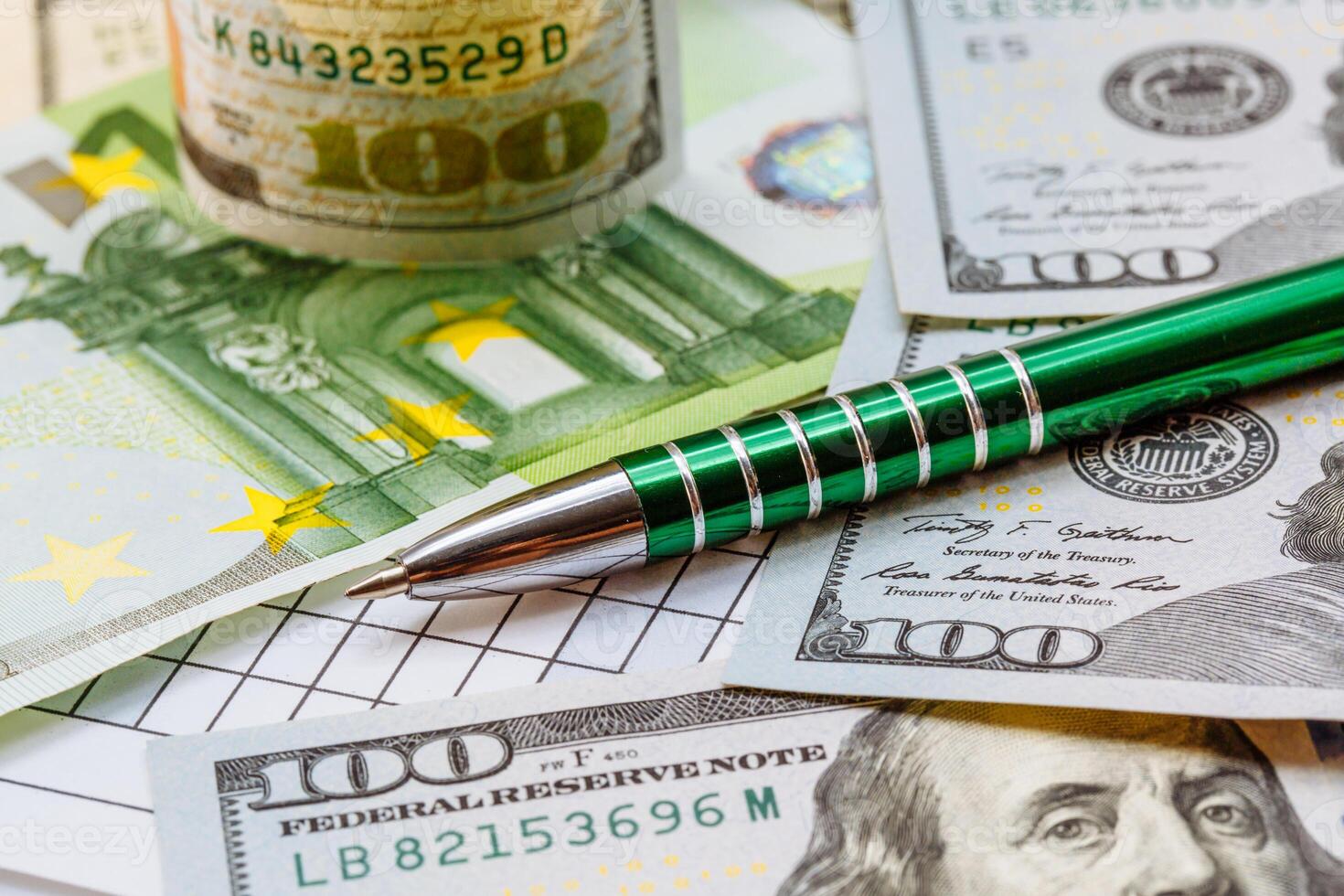 Background with money. American one hundred dollar bills. Euro banknotes. A ballpoint pen next to the bills. Money. Currency. photo
