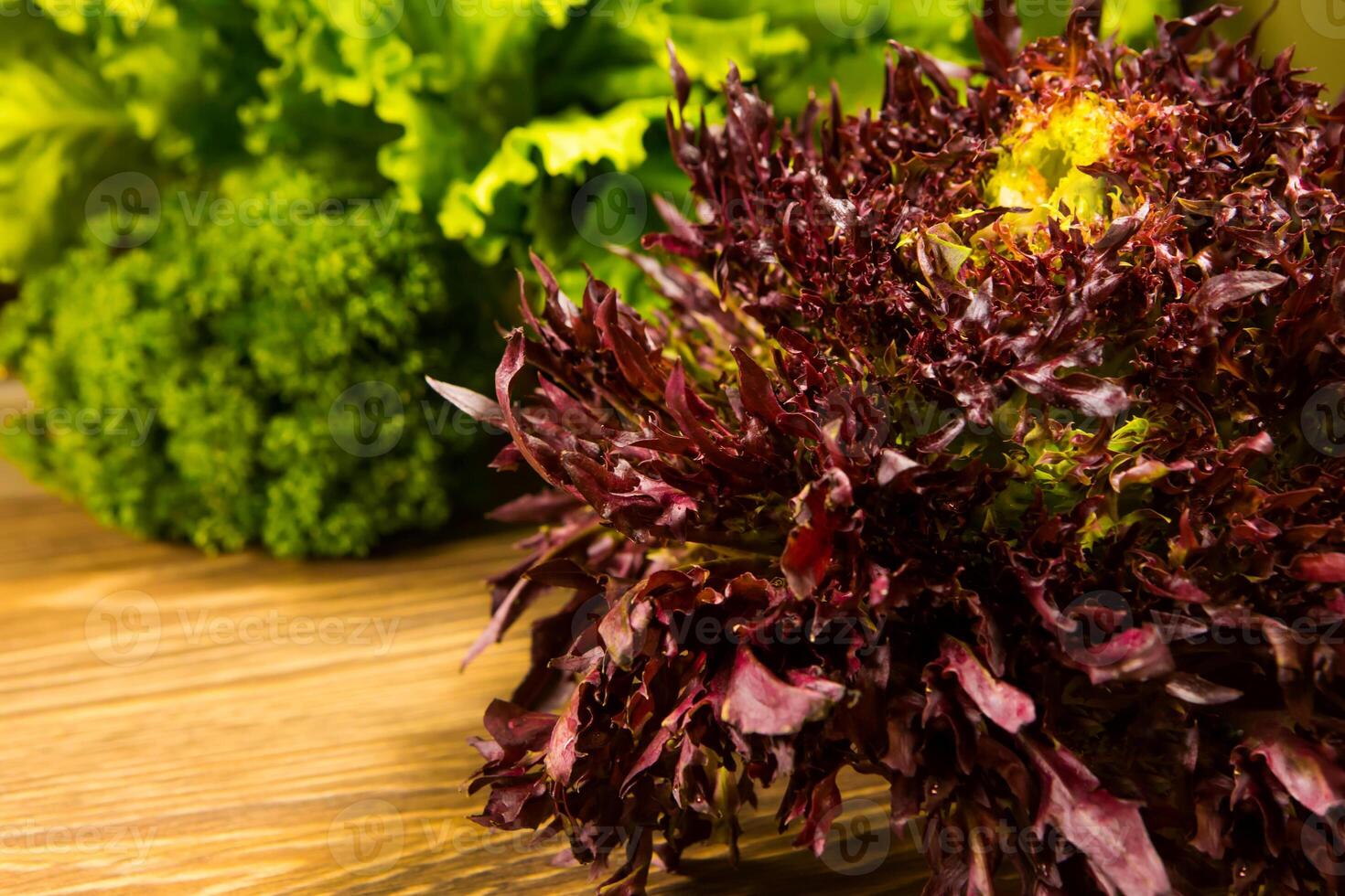 Leaves of lettuce and basil on a wooden background. Seasoning for the kitchen. photo