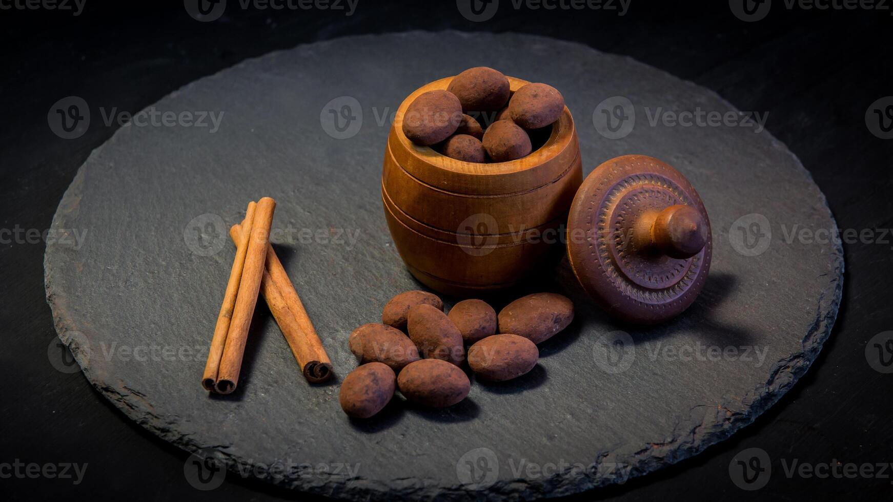 Chocolate truffle. Truffle chocolate candies with cocoa powder. Gourmet assorted truffles made by chocolatier.Chunks of chocolate and coffee beans photo