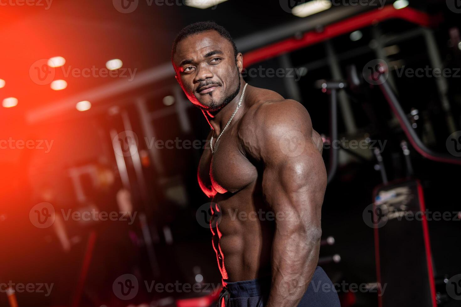 Athletic body. Shirtless model guy is posing to the camera. Strong muscular african american man with perfect body. photo