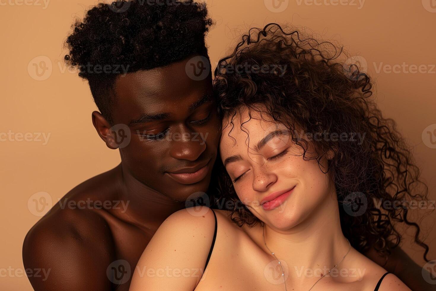 Intimate Portrait of Smiling Couple Embracing Against Warm Beige Background, Expressing Love and Joy photo