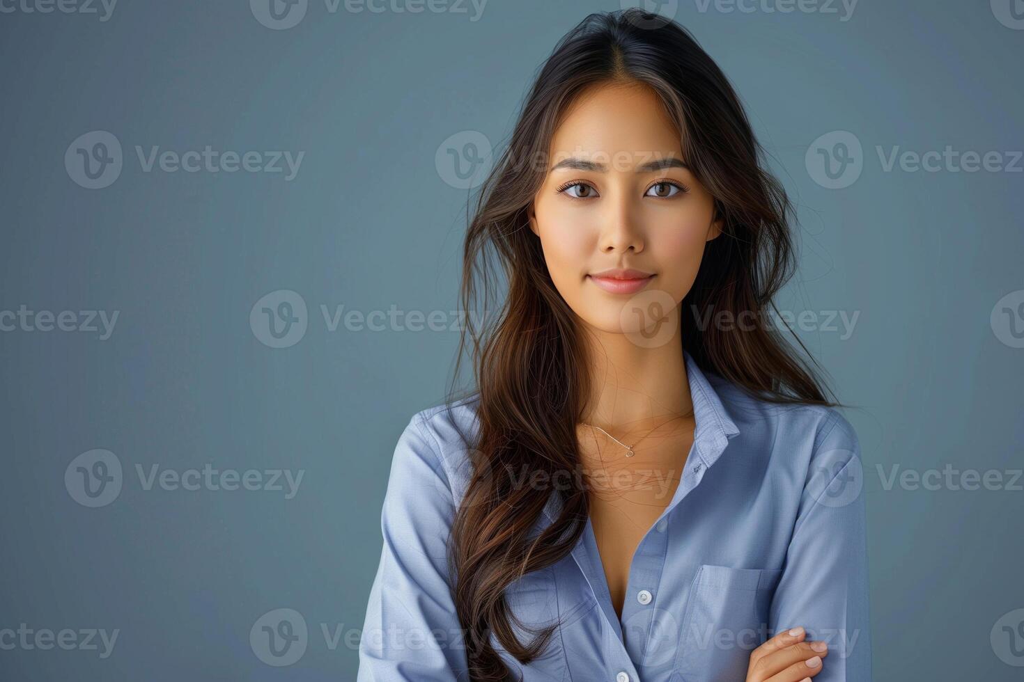 Professional Portrait of Confident Woman in Business Casual Attire Against Subtle Blue Background for Corporate Profile, Headshot, and Marketing Use photo