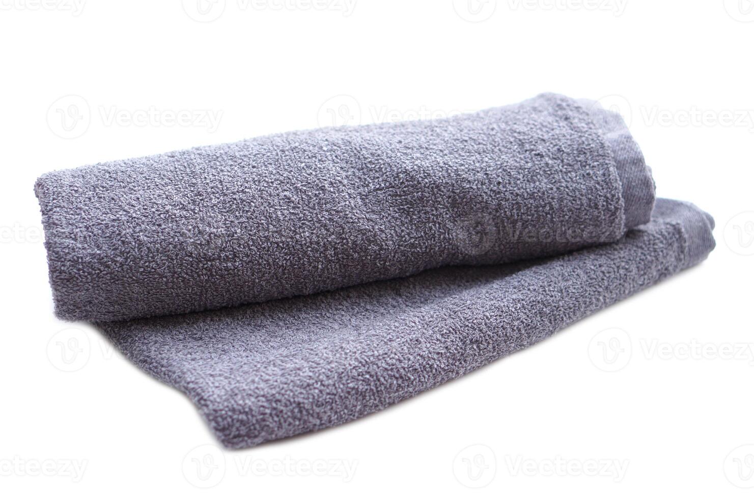 Gray towel isolated on white background. Concept, clothes in daily life using. Towel for bathing, showering or spa massage. photo