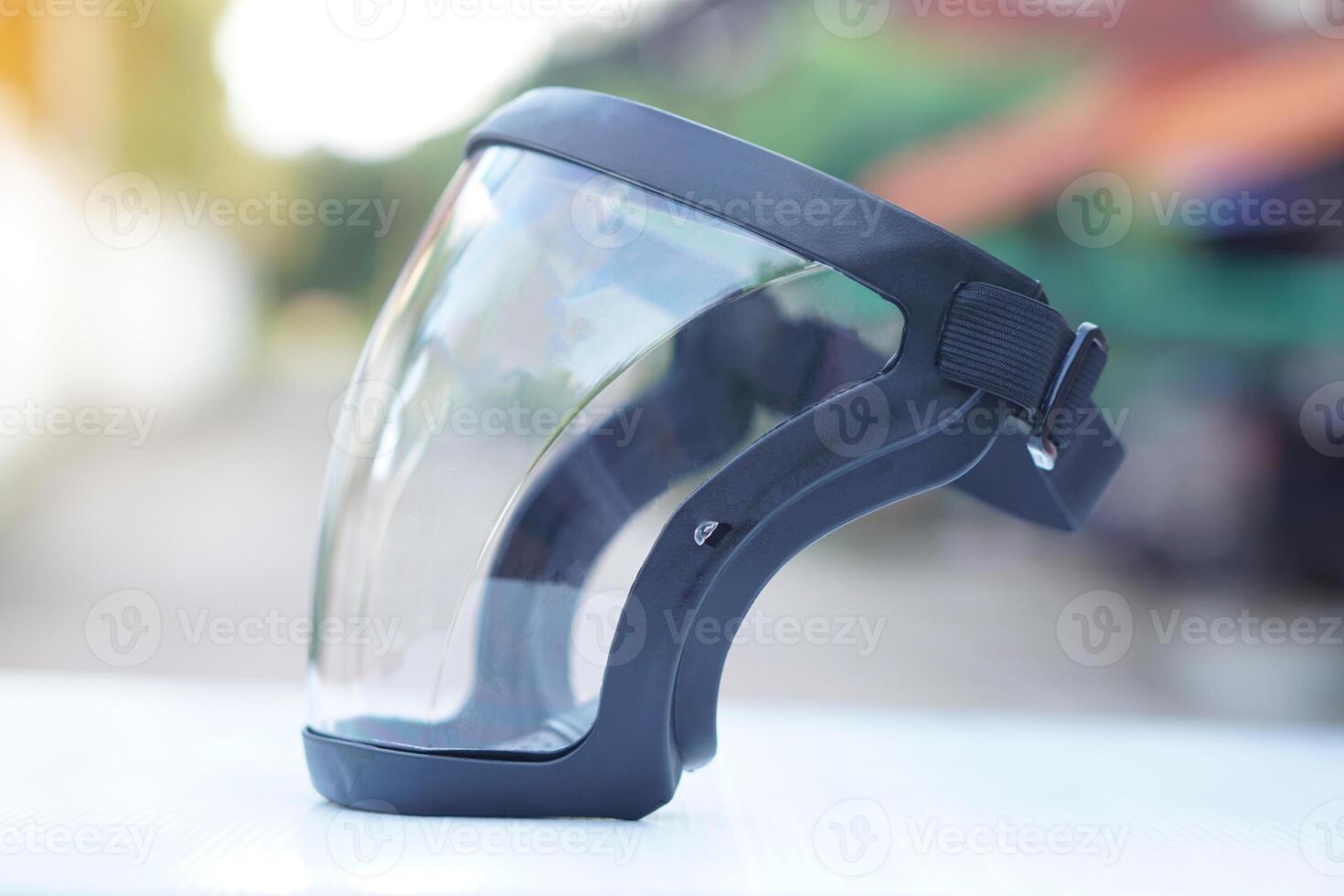 Protective safety face shield, Clear glass with black edge. Concept, tool, equipment use for wearing with face to protect from dust, germ spreading or others into face. Work Secured helmet shield. photo