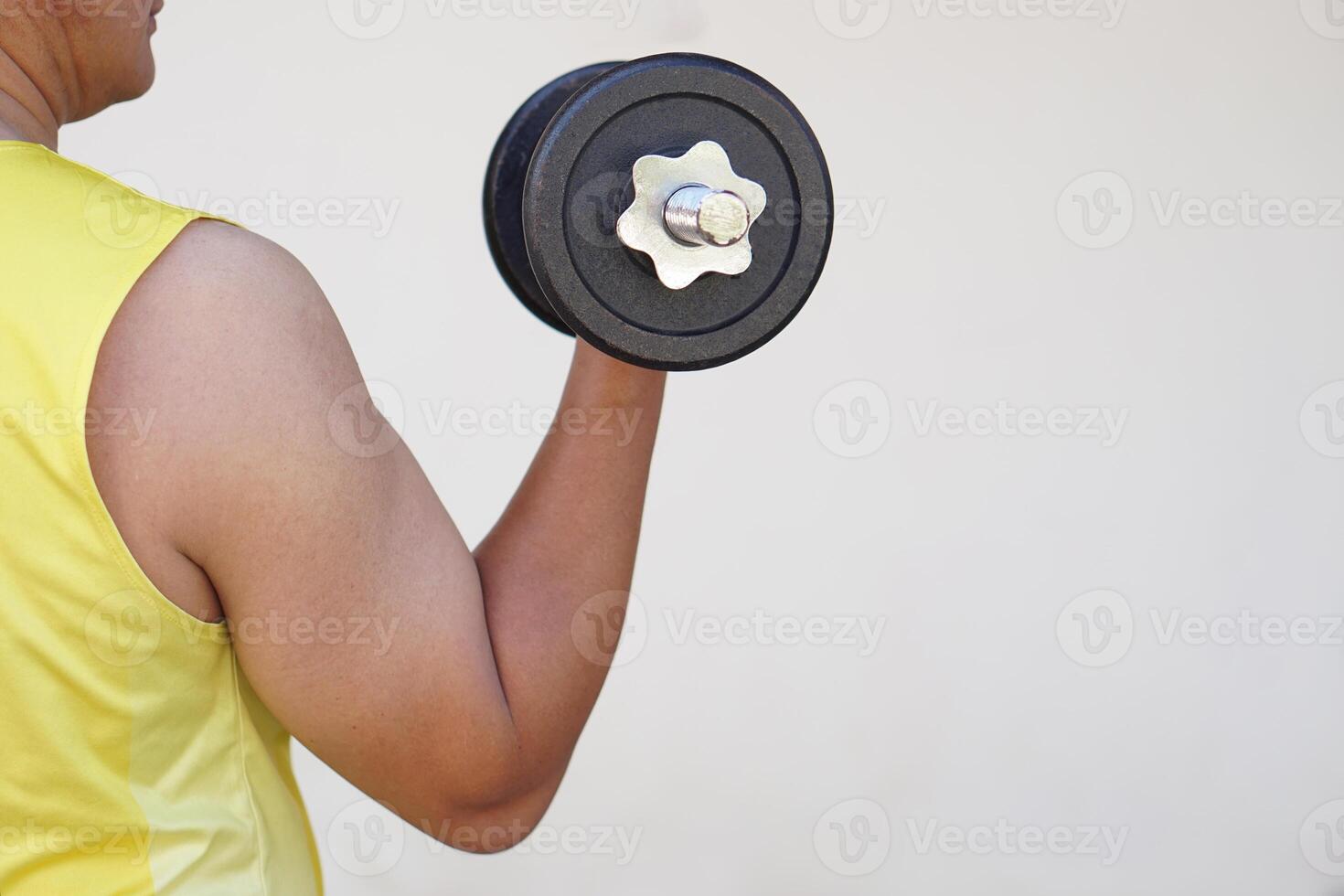 Close up man lift dumbbell isolated on white background. Concept, sport equipment. Exercise for health bodybuilding. Strengthen muscle. Weight lifting. Healthy lifestyle photo