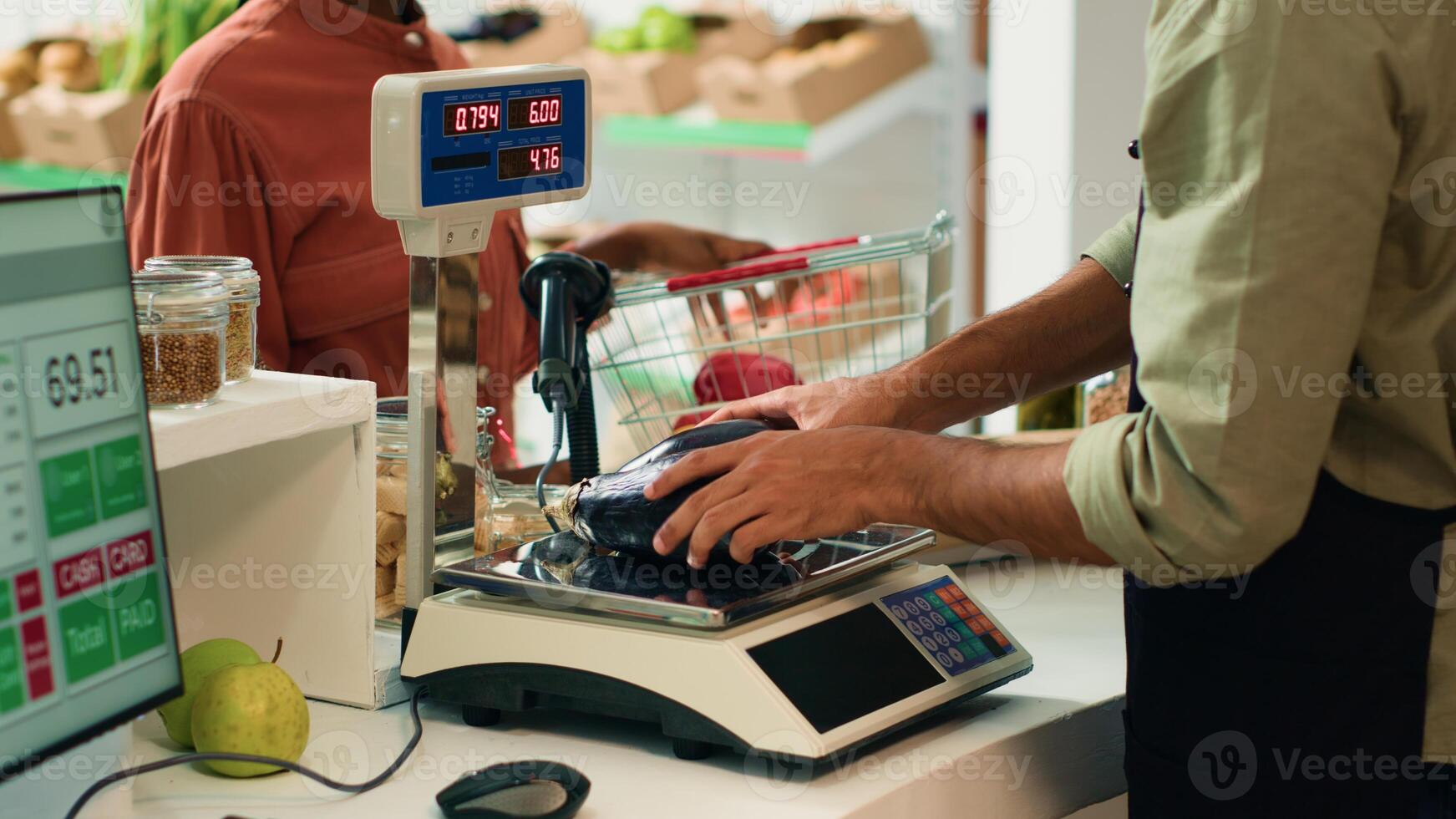 Merchant weighting produce for client, placing fruits and vegetables on scale to ensure right price at local zero waste eco store. Small business owner serving female customer with groceries. photo