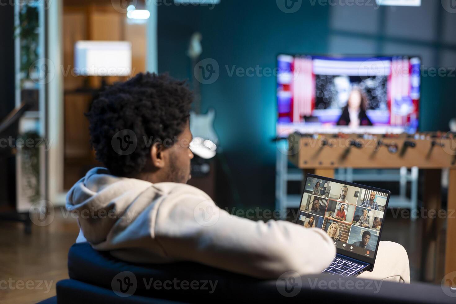 Remote worker in teleconference meeting chatting with multi ethnic international team while working from home. Man in online videocall with colleagues from cozy apartment photo