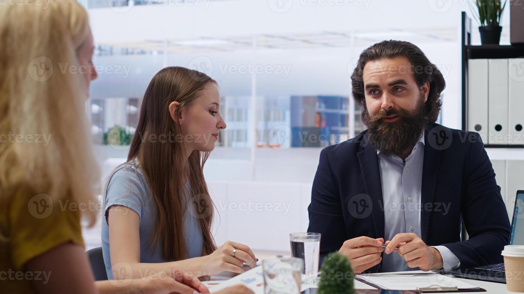 Parent and child looking over personalized planning guide written by financial advisor during meeting. Consultant optimizing spending habits of clients requesting help, camera B photo