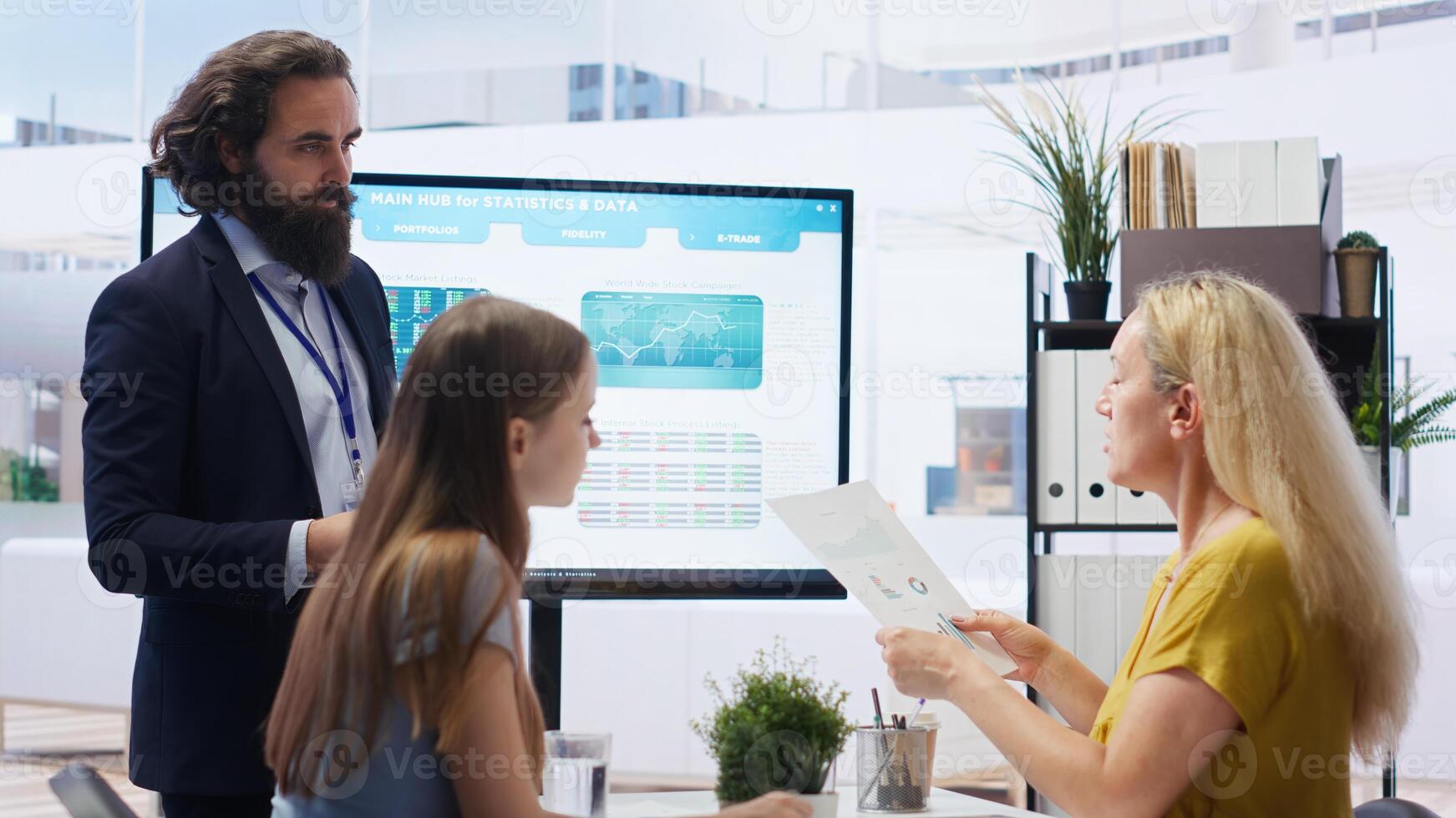 Financial advisor discussing with clients, recommending suitable financial products such as mutual funds. Agent teaching parent and daughter how to invest, offering statistical graphs, camera B photo
