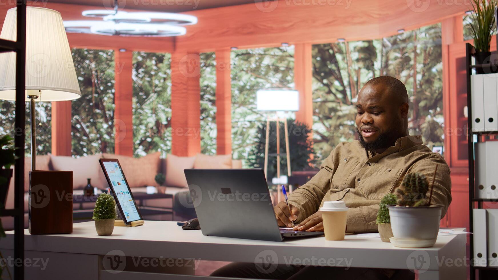 Entrepreneur transmitting financial data reports and discussing resources allocations with shareholders on a videocall from his home desk. Businessman meets with investors online. Camera B. photo