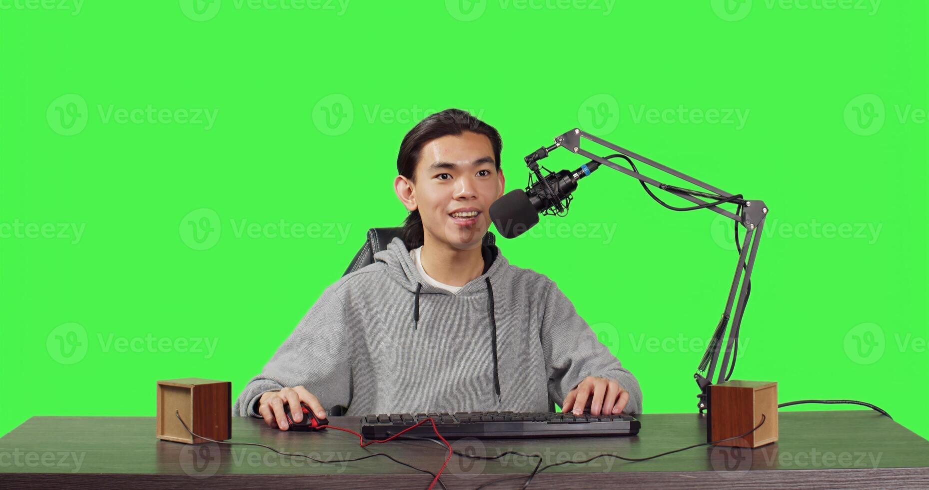 POV of blogger on live stream recording game of new adventure videogames launched, full body greenscreen backdrop. Asian streamer broadcasting rpg web competition, streaming with microphone. photo