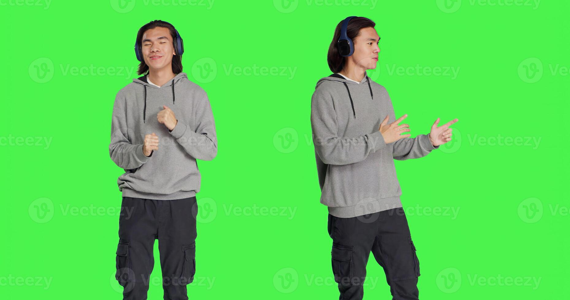 Male model listening to music and dancing around studio with audio headset, having fun with songs and funky dance moves. Cheerful person feeling optimistic and groovy, greenscreen. photo