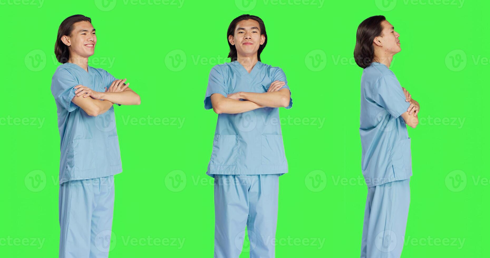 Friendly nurse posing in studio with confidence, wearing clinical uniform and standing with arms crossed over greenscreen backdrop. Young medical assistant working in healthcare industry. photo