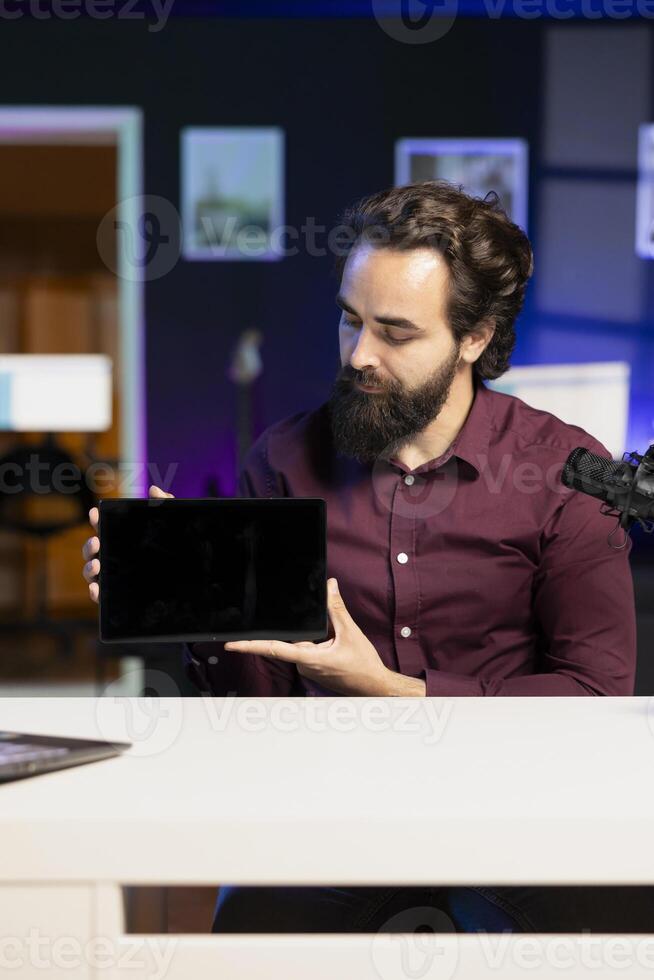 Media star in studio filming tech tutorial on how to do maintenance on broken tablet. Technology online show host teaching subscribers how to open and fix damaged digital device photo