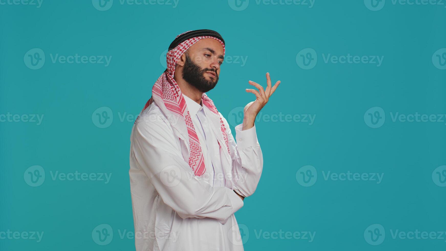 Middle eastern adult acting puzzled and thinking about new ideas, being interested in a subject and trying to obtain answer. Young person being curious on camera, wondering about solution. photo