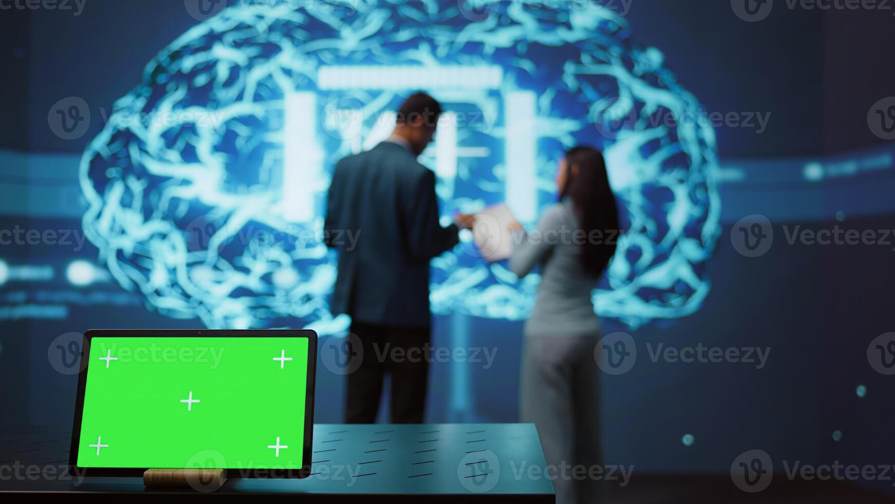 AI programmers colleagues using green screen laptop for business data analysis. IT experts in high tech location work on chroma key notebook to automatize tasks using artificial intelligence, camera B photo