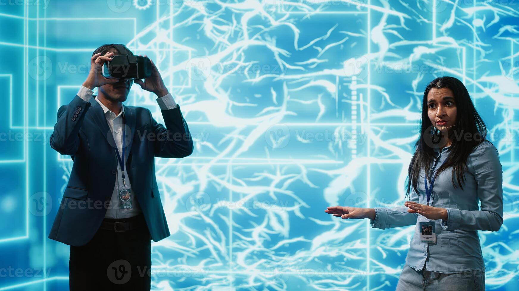 Tech experts presenting VR headset and AI tech during summit presentation, exploring successful implementation of artificial intelligence and virtual reality in driving forward businesses, camera A photo
