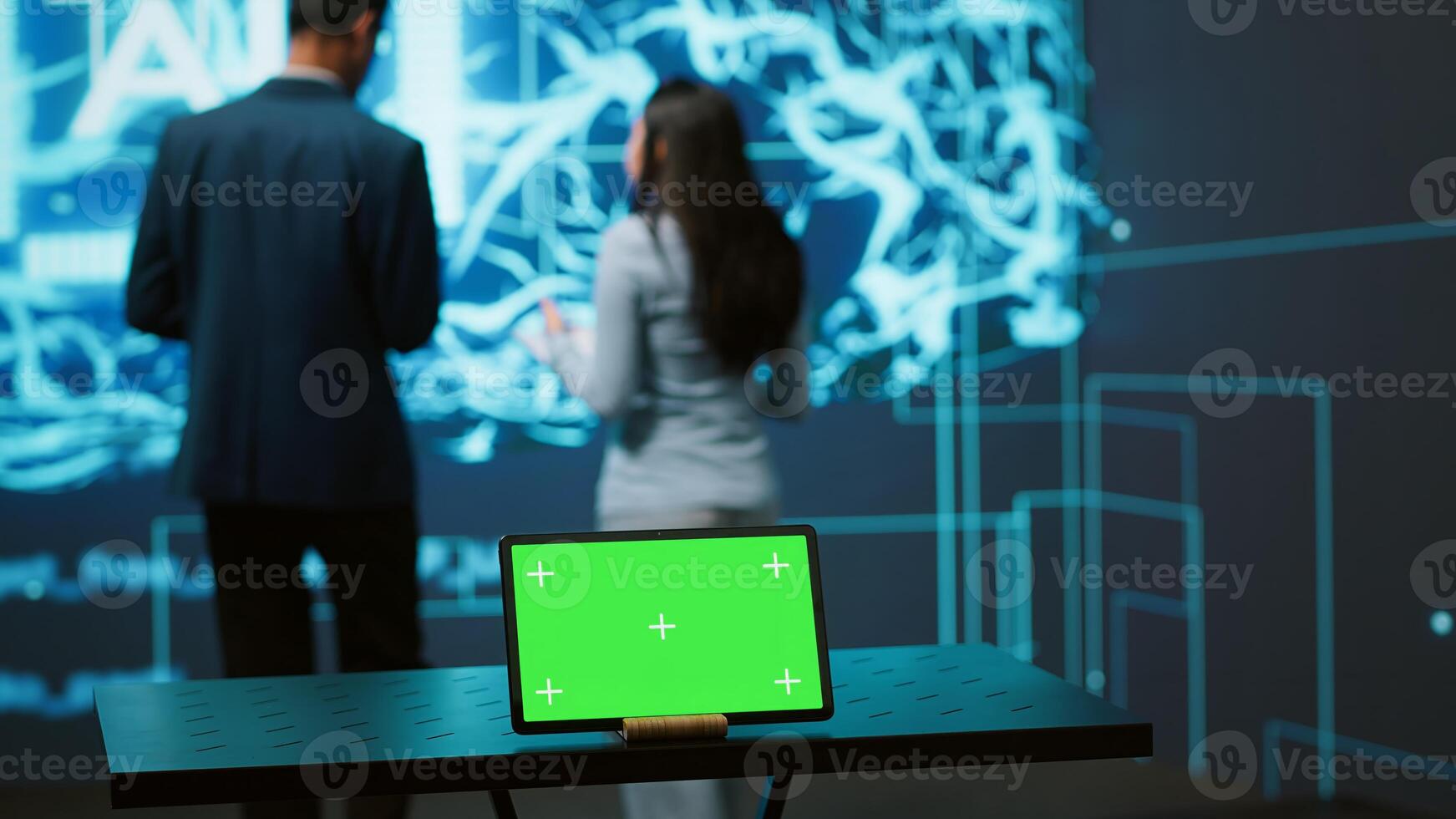 AI programmers colleagues using green screen laptop for business data analysis. IT experts in high tech location work on chroma key notebook to automatize tasks using artificial intelligence, camera A photo