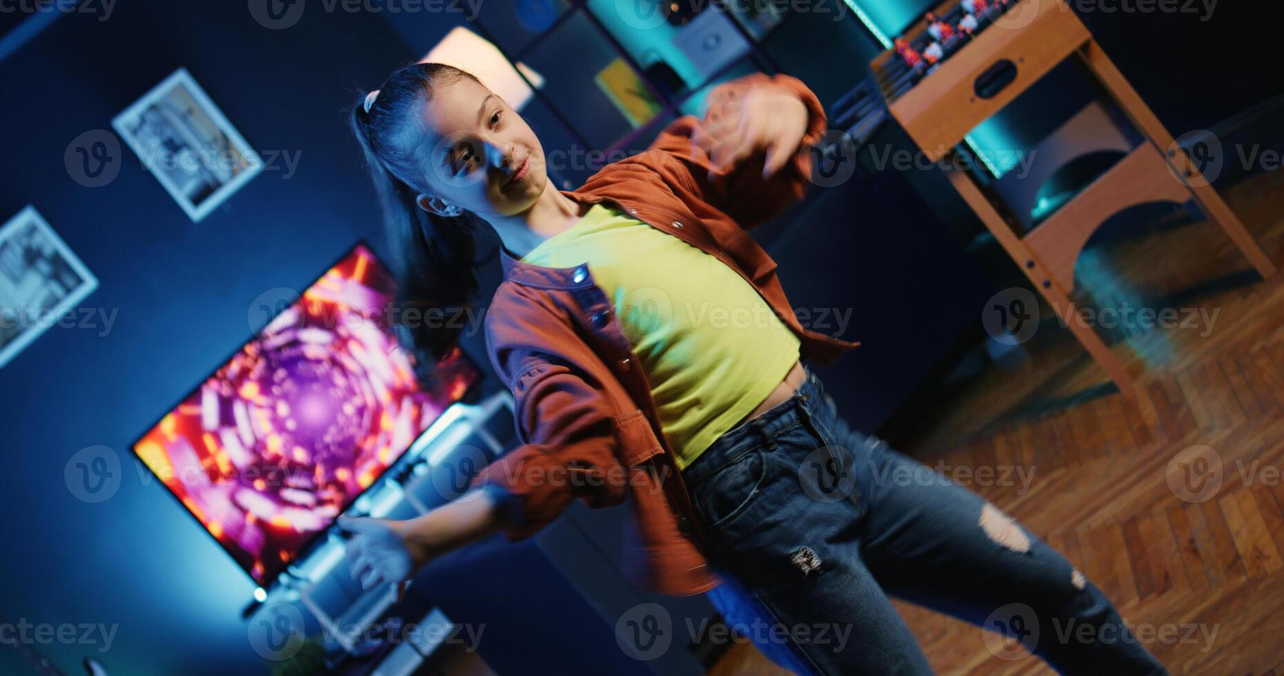 Cute kid getting tons of engagement on her dancing clips posts on social media platforms. Influencer child filming viral videos, impressing audiences with energetic dance moves photo