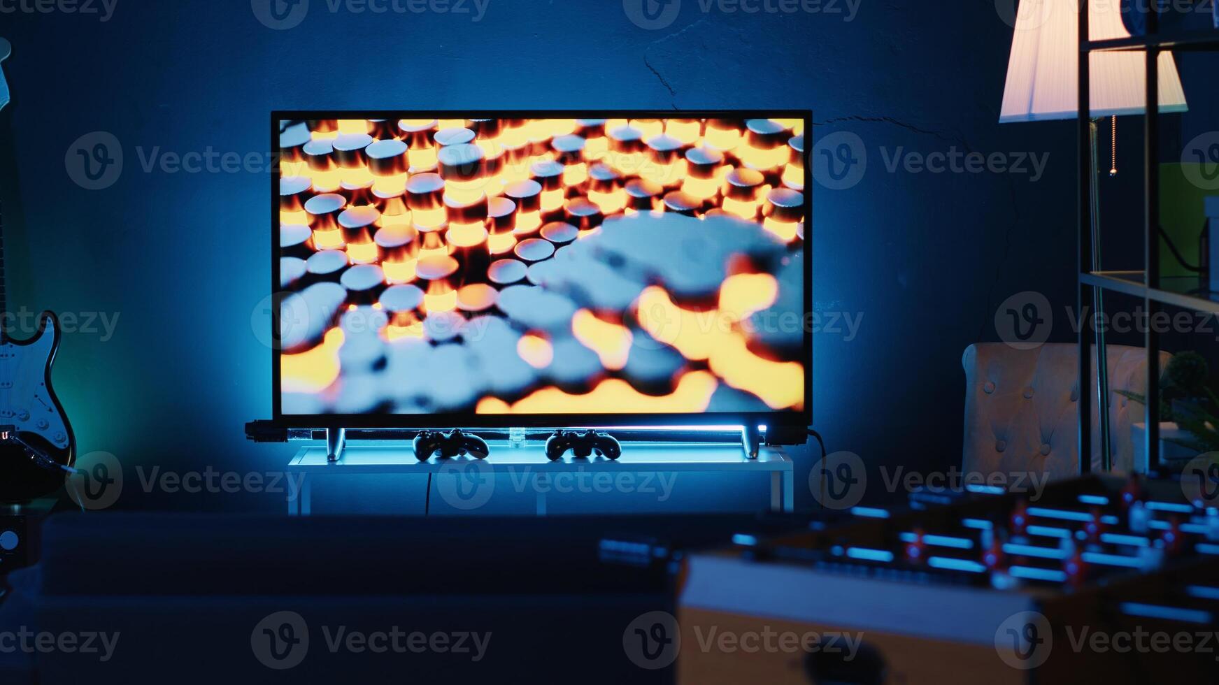 Close up shot of 3D rendered animations running on TV screen in empty house with warm lighting. Living room apartment illuminated by neon lights and decorated with stylish modern home decor photo