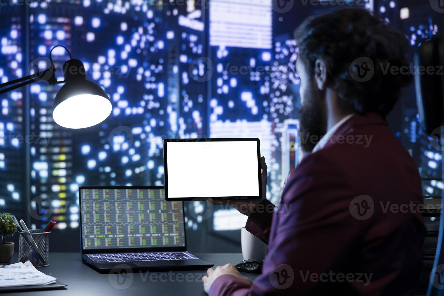 Rich shareholder looking at blank tablet screen after hours, enjoying skyscraper urban view. Businessman working with financial analytics and white mockup display on device, global company. photo