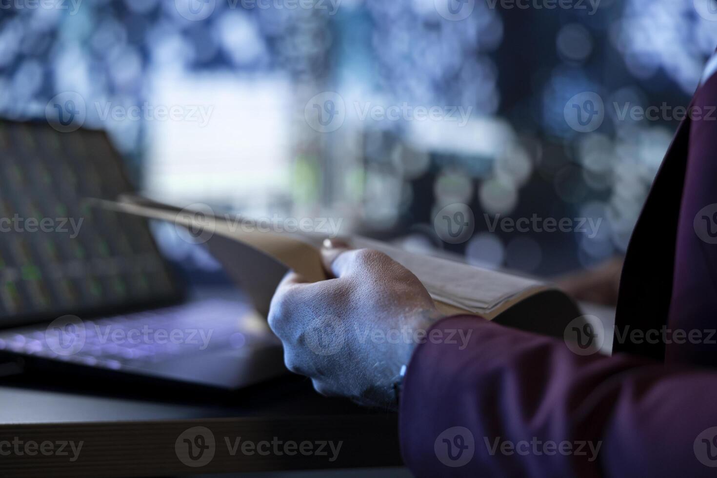 Businessman reading monthly accounting documents to ensure international development, following stock market trend at night. Shareholder working with legal papers, creating investment plan. Close up. photo