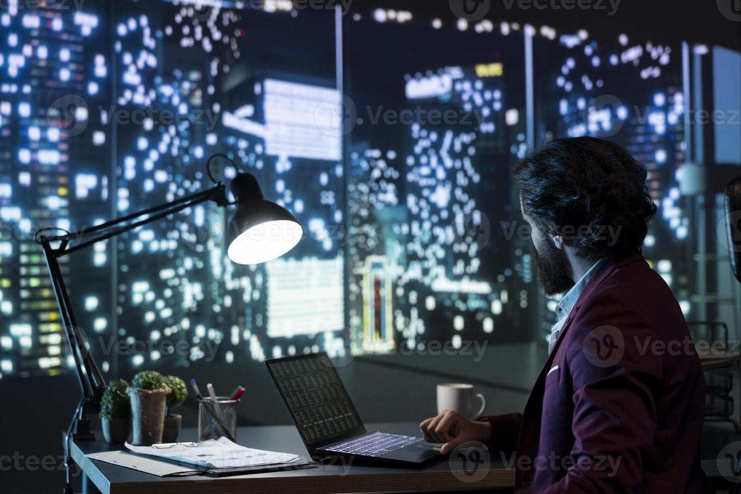 Private equity manager analyzing financial reports at night, examining investment transactions to help expand activity on international scale. Advisor follows stock market trends online. photo