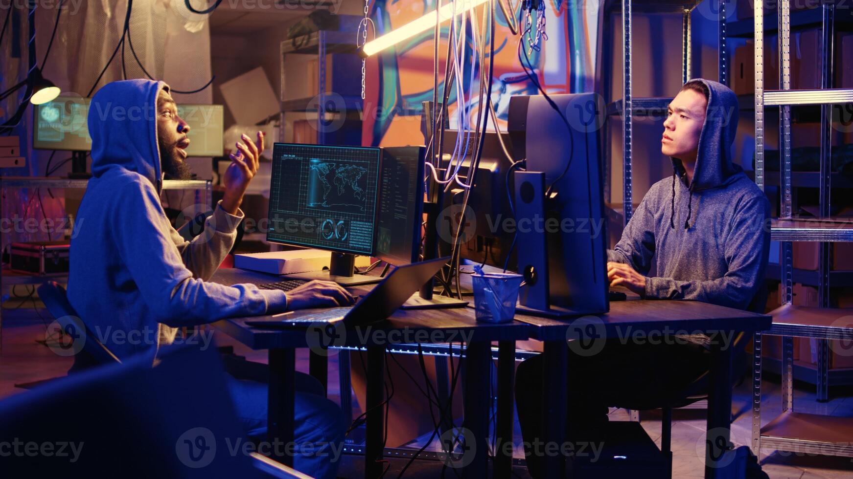 Hackers brainstorming ways to go undetectable by antivirus software installed on systems and successfully trick firewalls, discussing methods of developing zero day exploit in secret bunker photo