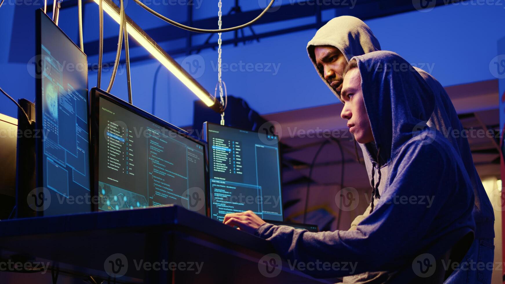 Hackers brainstorming ways of getting past anti tamper measures implemented by companies trying to protect their products. Crackers trying to pirate software and game releases photo
