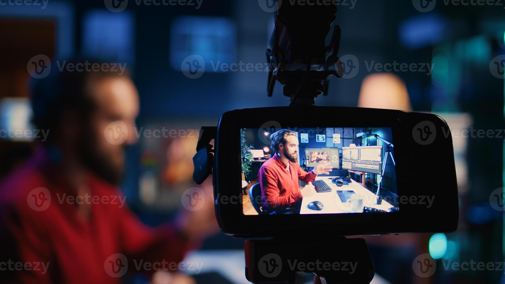 Focus on professional camera filming photographer in blurry background offering image retouching tips to viewers. Recording gear used by photo editor making online photography tutorial, close up