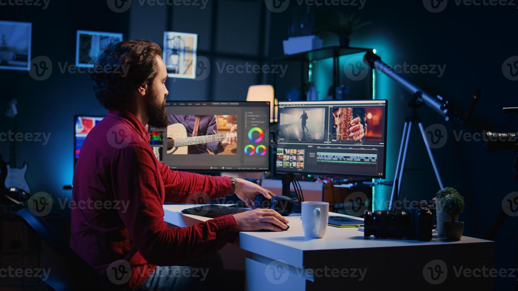 Videographer starting work on create visual effects for projects using professional software. Specialist starting his day with cup of coffee in post production studio, editing raw footage photo