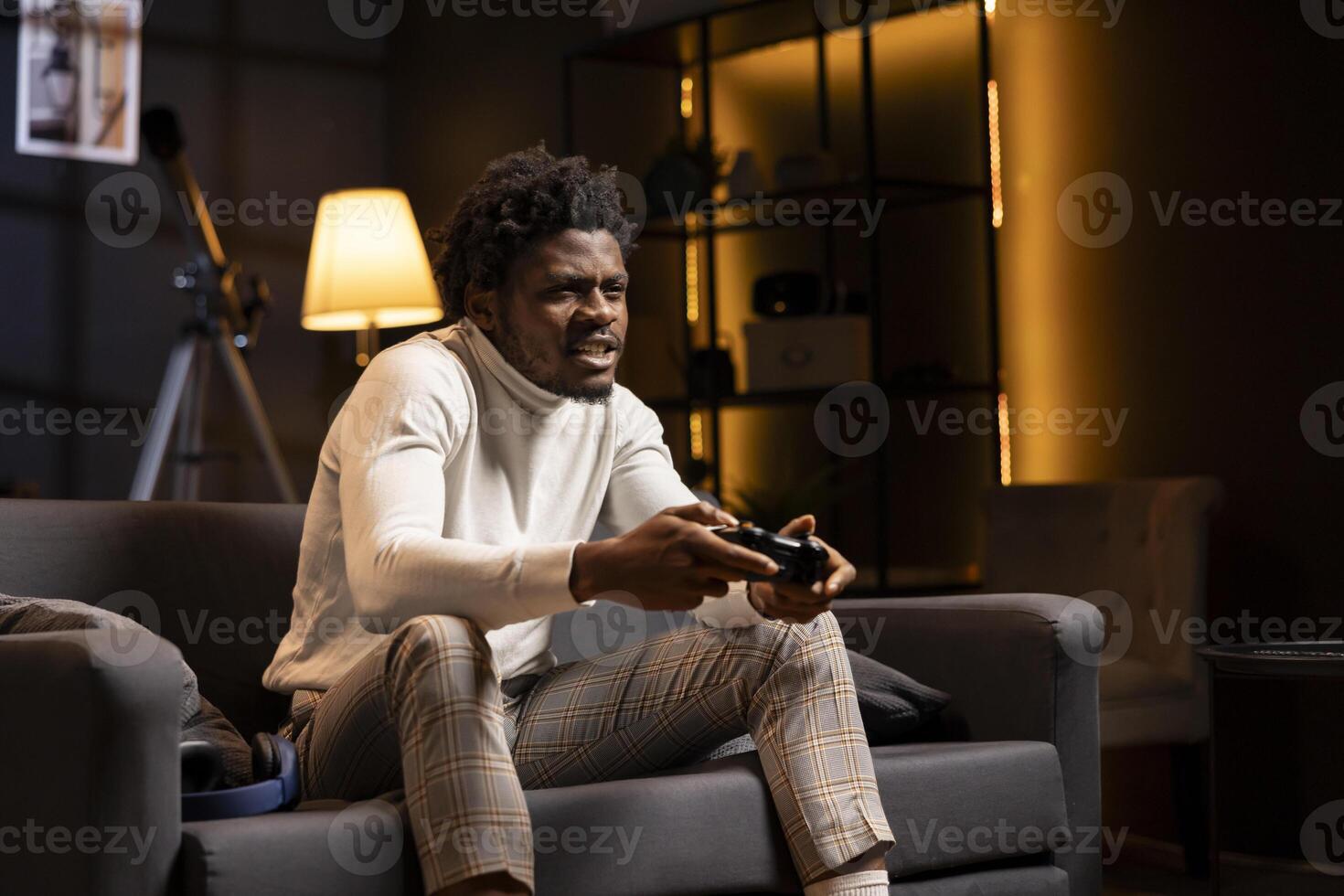 Man looking in disbelief at smart TV display while playing videogames, receiving game over screen on gaming console. Gamer upset after being defeated by rival players in online esports competition photo