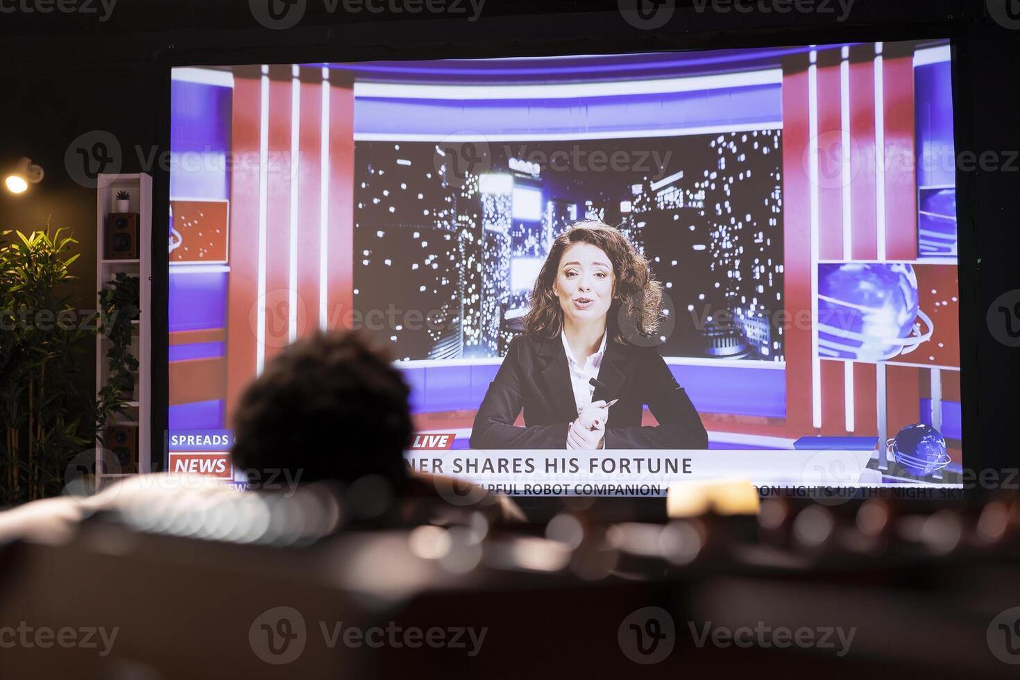 Man lounged on cozy couch, watching breaking news broadcast while relaxing in apartment. Homeowner chilling on couch, looking at VOD TV channel showing journalism reportage photo