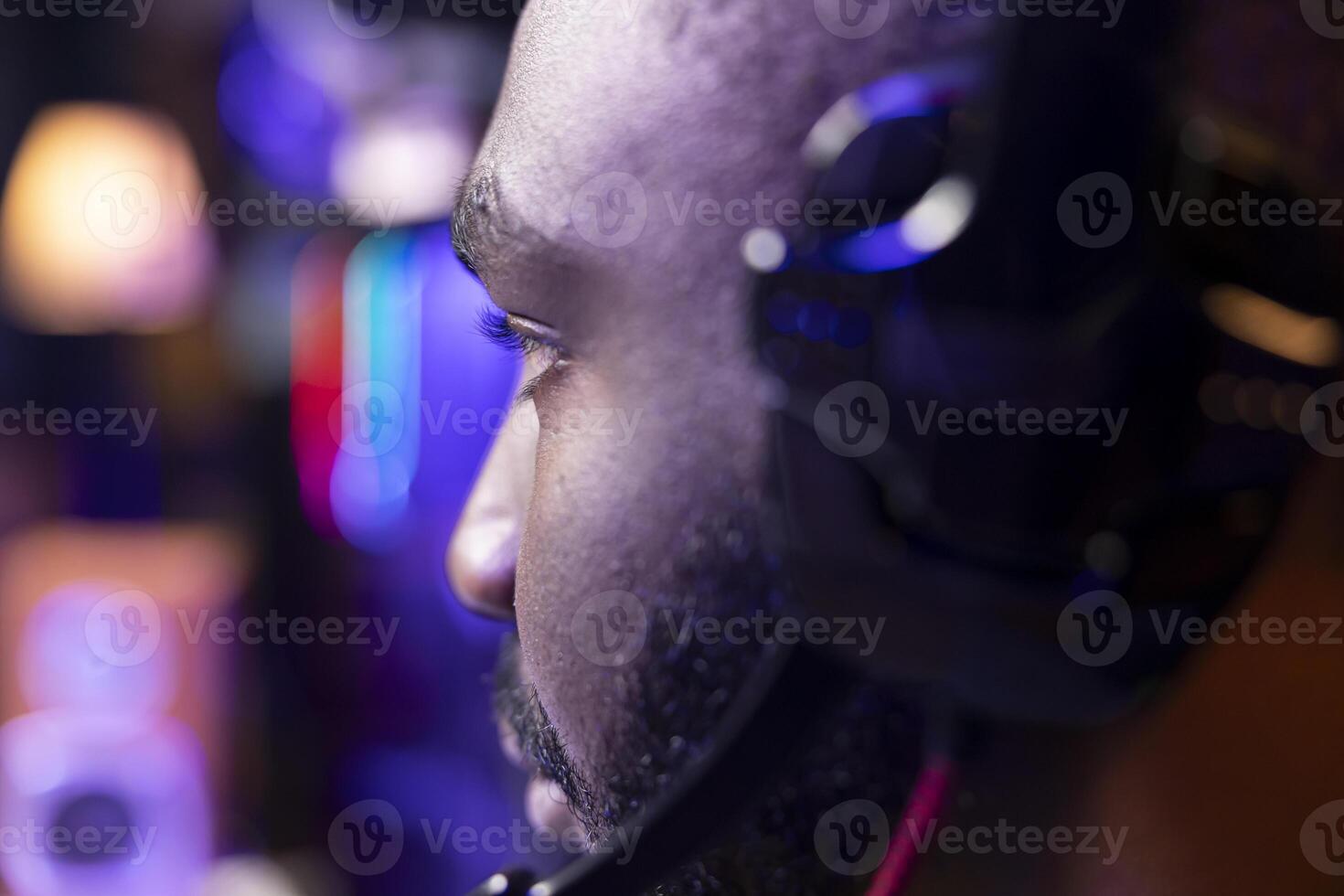 African american man wearing headphones playing game, teaching subscribers professional esport skills, close up shot. Media star using headset mic to chat with viewers, filming gaming tutorial photo