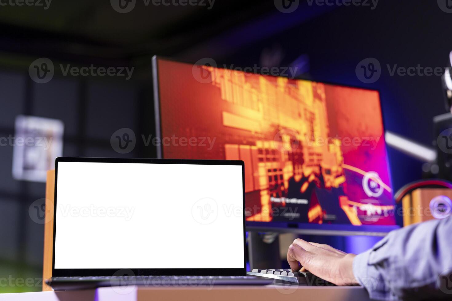 Mockup laptop display next to player using keyboard to play FPS videogame, shooting enemies. Isolated screen notebook near person gaming on computer desktop at home, close up shot photo