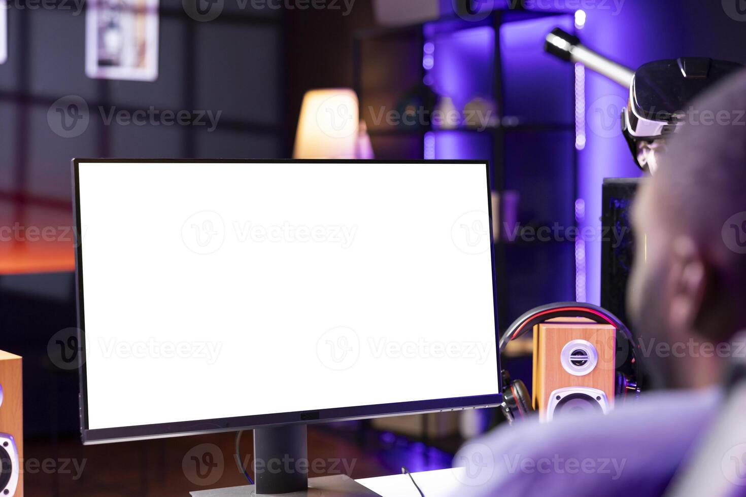 Player looking at gaming PC isolated screen, playing singleplayer videogame in neon lit apartment. Man in RGB illuminated home using enjoying game on mockup computer monitor photo