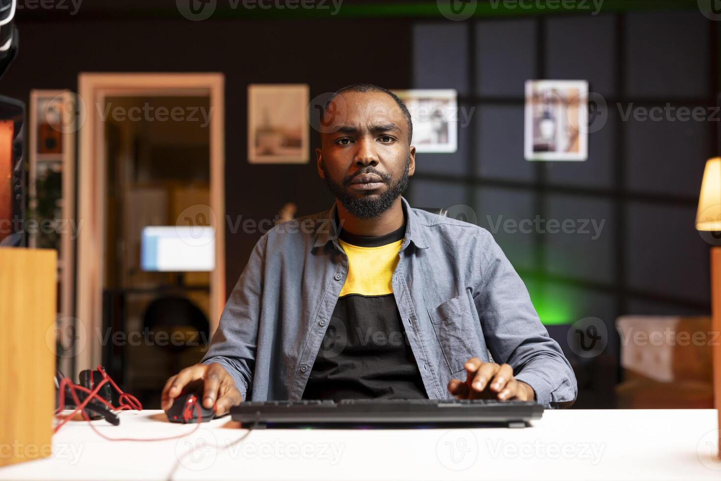African american man struggling to defeat opponents while playing esports competition, unhappy with his performance. Upset BIPOC player losing while competing in multiplayer videogame photo