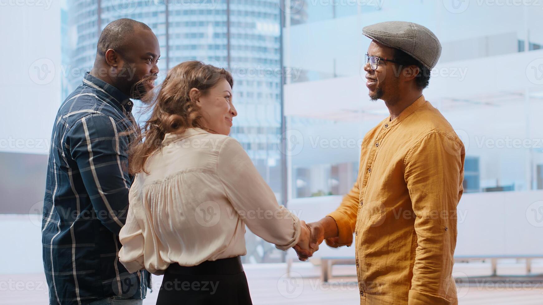 Skilled realtor salesman greeting business people for an office tour, examining new corporation workspace in an urban high class building. Development with real estate investment strategy. Camera B. photo